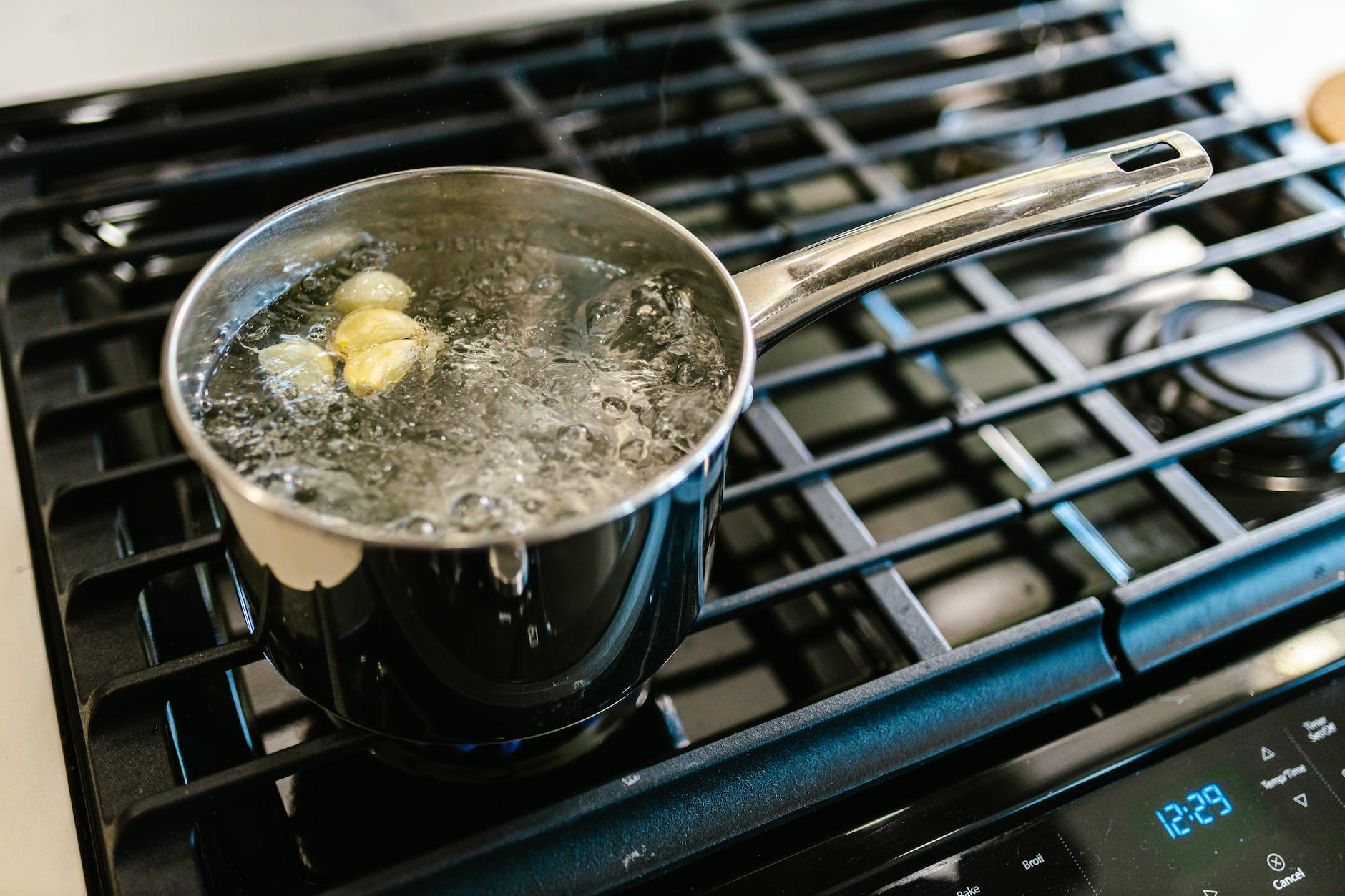 pot with boiling water and garlic