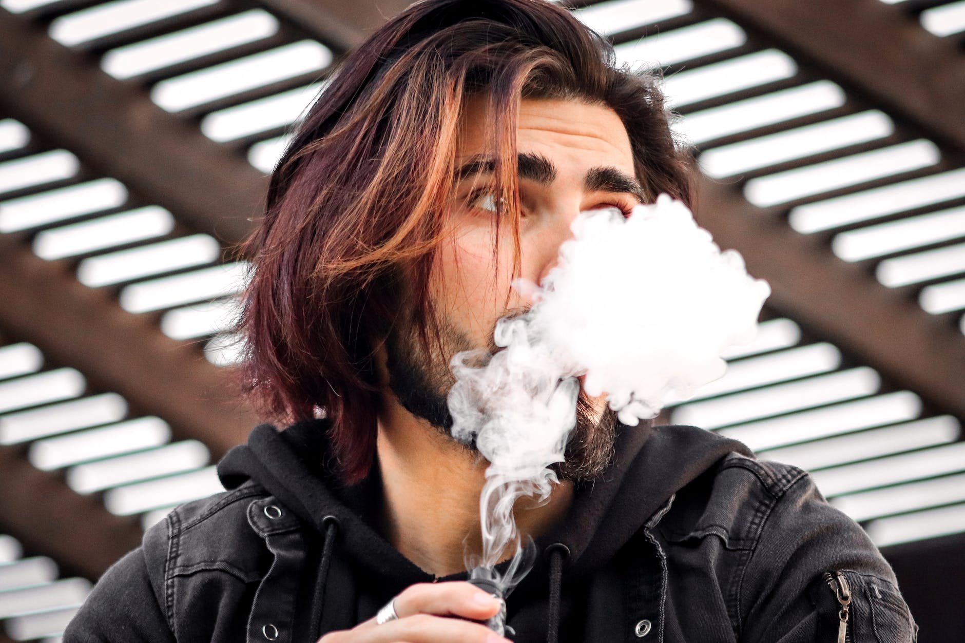 a man puffing a vape