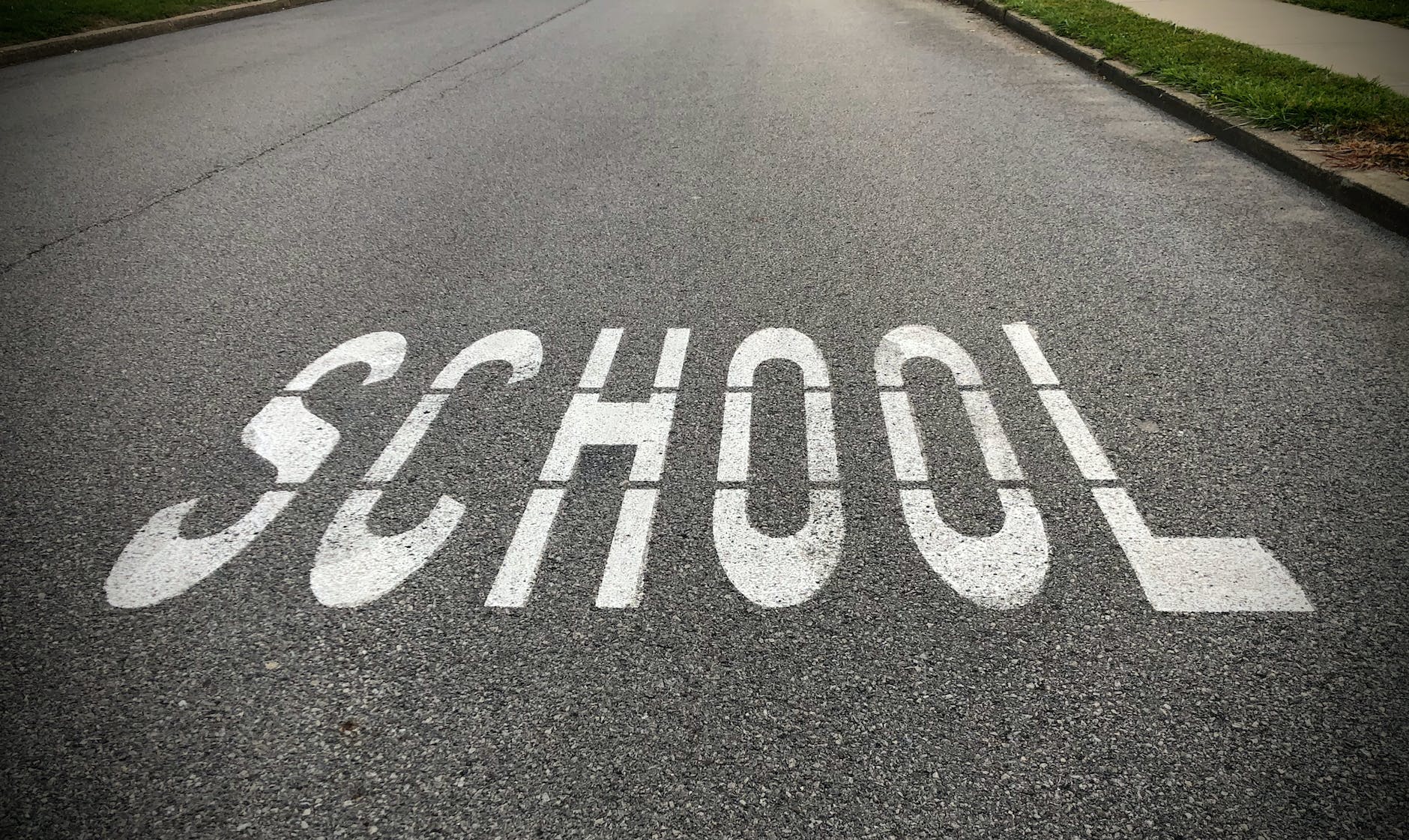 school zone warning sign on asphalt road