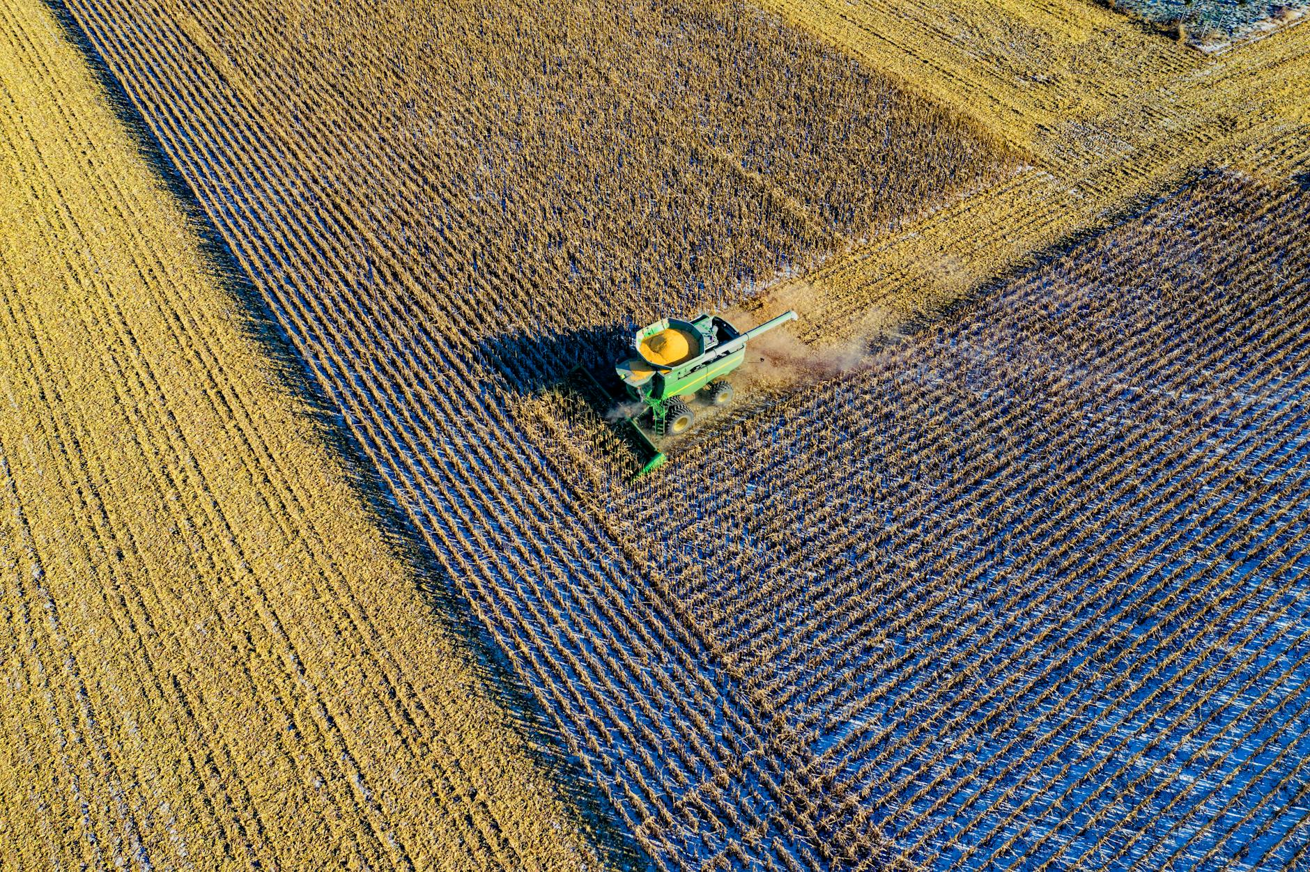 aerial photo of milling truck on field harvesting crops
