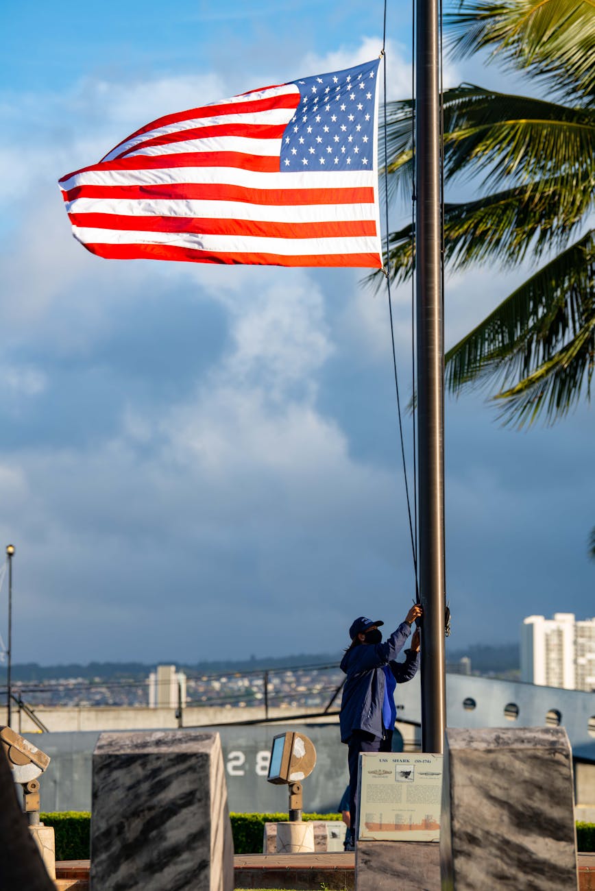 man raising the american flag