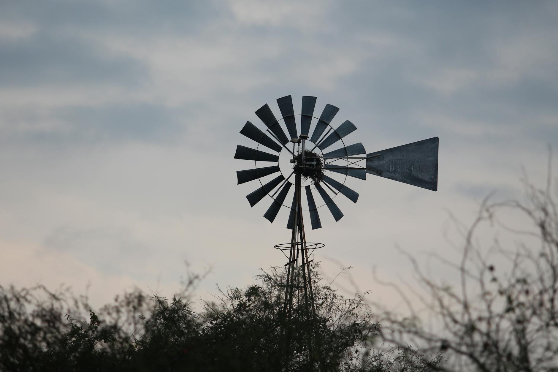a windmill under gray clouds